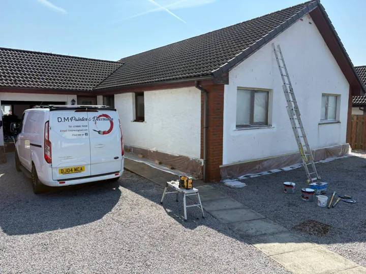 Bungalow exterior masked and prepared for masonry painting, with the D.M Painter & Decorators van on site